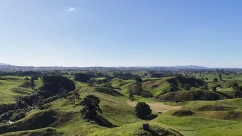 Drone flying forward over rolling green hills landscape with wide countryside Stock Footage 332592598