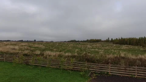 Drone flying forward over rural field toward horizon Видео 333956011
