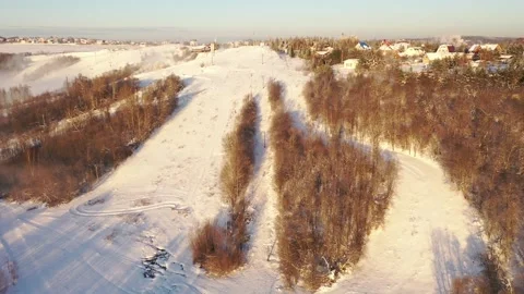 Drone flying forward over snowy ski resort Vidéo 323539077
