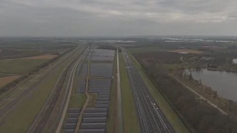 Drone flying forward over solar farm, highway and railway infrastructure Stock Footage 330189973