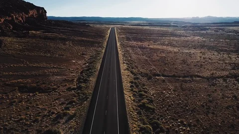 Drone flying forward over straight desert highway road in USA wilderness near Stock Footage 95942208
