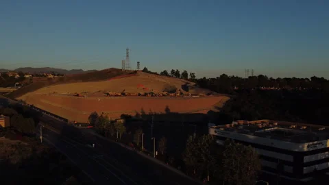 Drone Flying Forward Over Sunlit Hillside at Sunset. Stockbeeldmateriaal 335736114
