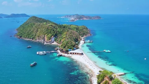 Drone flying forward over a white sand isthmus connecting two islands 4K Stock Footage 333938991