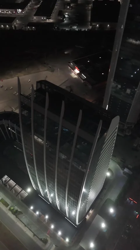 Drone flying forward passing modern buildings towers, above busy traffic road Stock Footage 285345268