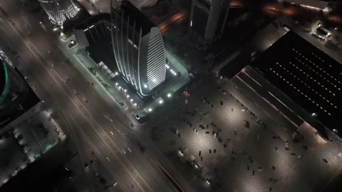 Drone flying forward passing modern buildings towers, above busy traffic road Stock Footage 285360794