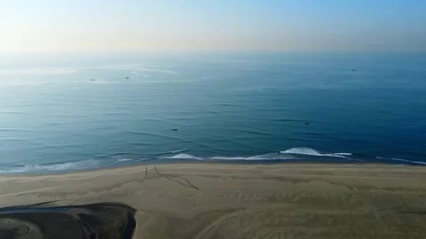 Drone flying forward from sandy beach over sea waves toward ocean horizon Stock Footage 328588203