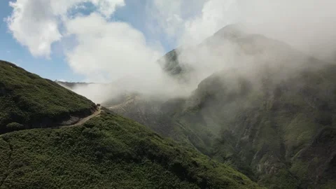Drone Flying Forward Through Mountains and Fog Stock Footage 260038600
