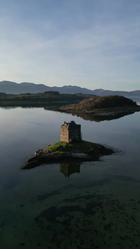 Drone flying forward toward island castle in Scotland 動画素材 334459512