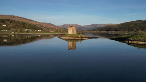 Drone flying forward toward island castle in Scotland 動画素材 334459701