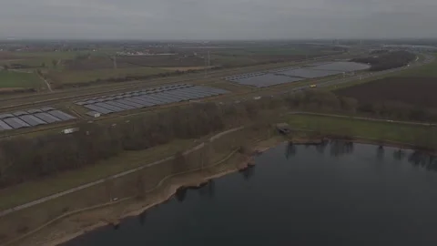 Drone flying forward toward solar farm near highway and railway Stock Footage 330189904