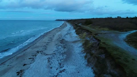 Drone flying forwards over desolate beach on a winter morning Video stock 287915076