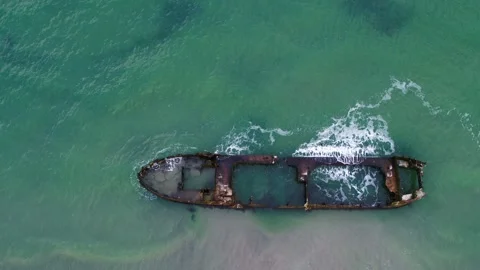 Drone flying forwards over old rusty shipwreck at the coast in Denmark Stock Footage 283072370