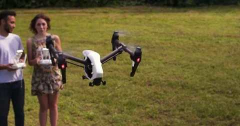 Drone flying in front of man and woman in a park Stock Footage 80304251
