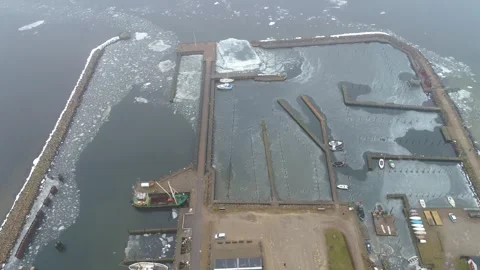 Drone flying high above over ice packed boat marina in Denmark Stock Footage 287914913