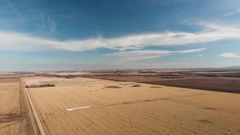 Drone flying high above a vast scene of autumn farm fields  Stock Footage 142596180