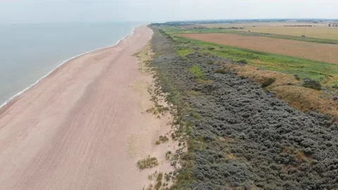 Drone flying high down the beach in the united kingdom Stock Footage 141462351