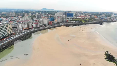 Drone flying high over beach towards town Video stock 91092242