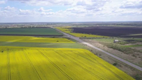 Drone flying high over a prairie landscape of blooming fields with a restored Stock Footage 143708533