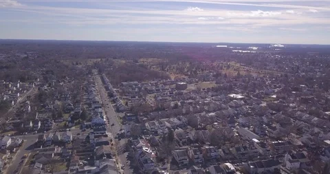 Drone flying high over town sun flare horizon 動画素材 100736604