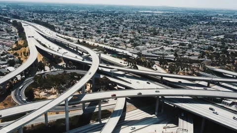 Drone flying left high above big Judge Pregerson freeway junction in Los Angeles Video stock 95709780