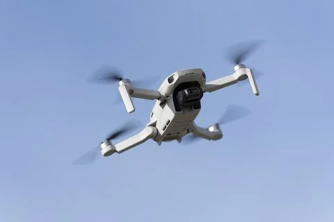 Drone flying with the light blue sky on the background Stock Photos