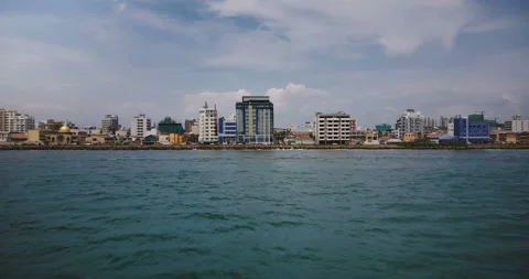 Drone flying low above the ocean water towards Colombo city coastline, Sri Lanka Stock Footage 93313449