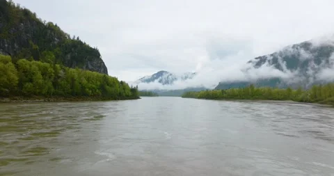 Drone Flying Low Along A Large River's Surface In Canadian Mountain Valley Stock Footage 266045147