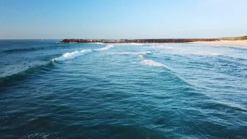 Drone flying low and parallel to beach as waves break below. Ballina, NSW, Video stock 106224080