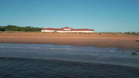 Drone flying low and slow over waves breaking on Littlehaven beach Stock Footage 315030216