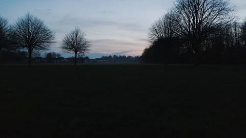 The drone is flying low to the ground. It's after sunset time with a bit Stock Footage 124769022