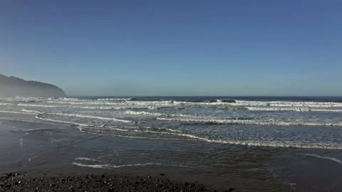 Drone flying low in the Oregon beach ocean in a sunny day Stock Footage 145821633