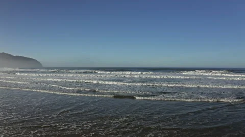 Drone flying low in the Oregon beach ocean in a sunny day Stock Footage 145821661