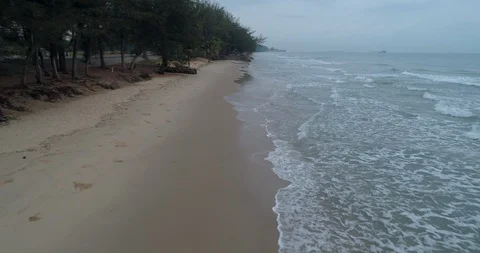 Drone flying low over the beach watching the waves roll in at Mae Pim Stock Footage 108415088