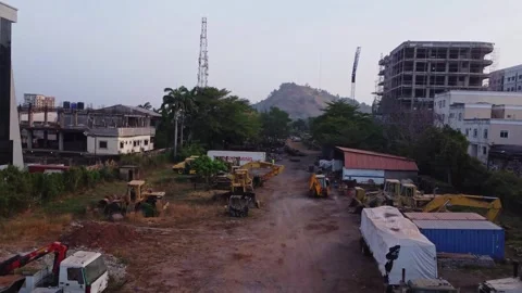 Drone flying low over a construction work yard with bulldozers and trucks in Stock-Footage 329097697