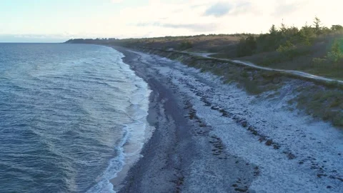 Drone flying low over desolate beach on a winter morning Stock Footage 287914989
