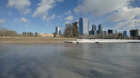 Drone Flying Low Over Frozen Ice Pond at Snowy Bellevue Washington Park Stock Footage 105441069