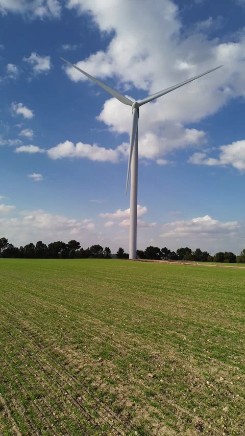 Drone Flying Low Over Green Cereal Field Approaching Wind Turbine Stock Footage 331119949
