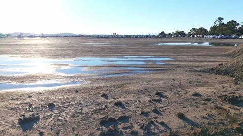 Drone flying low over a muddy wasteland after rain Stock Footage 340120935