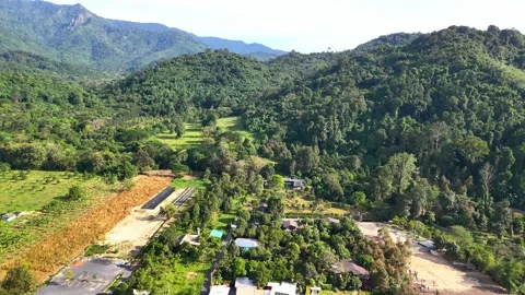 Drone flying low over a peaceful Thai countryside. Stock Footage 331029030