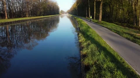 Drone flying low over river or canal and forest in Belgie Stock Footage 164119688