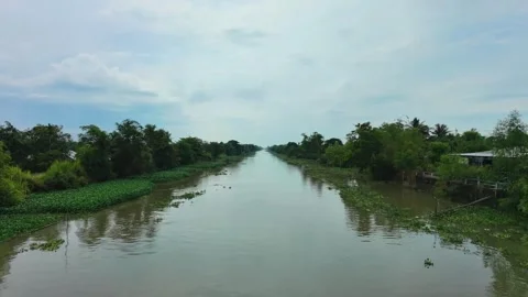 Drone flying low over a rural canal during high tide in Mekong Delta Stock Footage 337529049