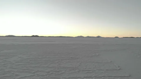 Drone flying low over the salt flat ground at Salar de Uyuni, Andes, Bolivia Stock Footage 175923091