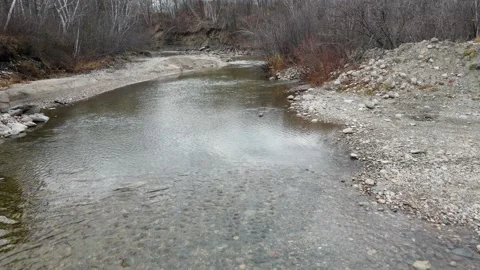 Drone flying low over a small rocky river with small rapids  Stock Footage 220451745