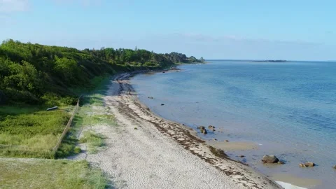 Drone flying low over small beach 4K Stock Footage 236723376