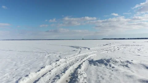 Drone flying low over the snow at first than rising higher showing the kite Stock Footage 164381025