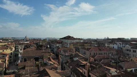 Drone flying low over tiled rooftops towards the Grand Canal in Venice, Italy Stock Footage 276358359