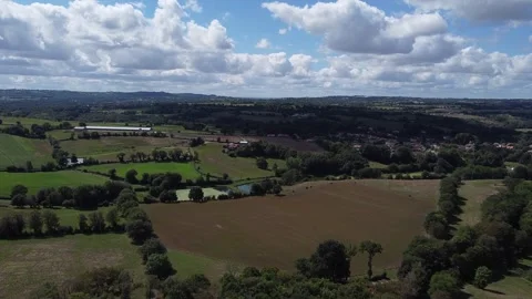 Drone flying low over vast fields with moving clouds in France Stock Footage 331710412