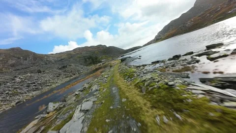Drone flying low over welsh slate quarry lake Stock Footage 327732052