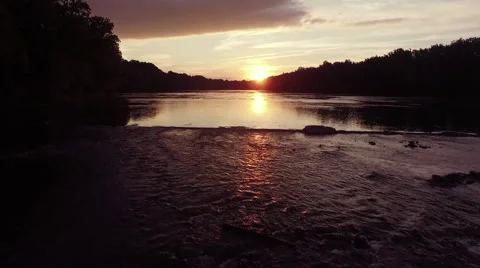 Drone flying low up river at sunset glass water refections Stock Footage 63909372