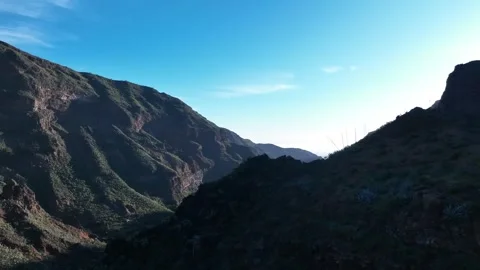 Drone Flying Up Mountain Side Revealing Sunlit Valley – Gran Canaria Aerial Stock Footage 309949164